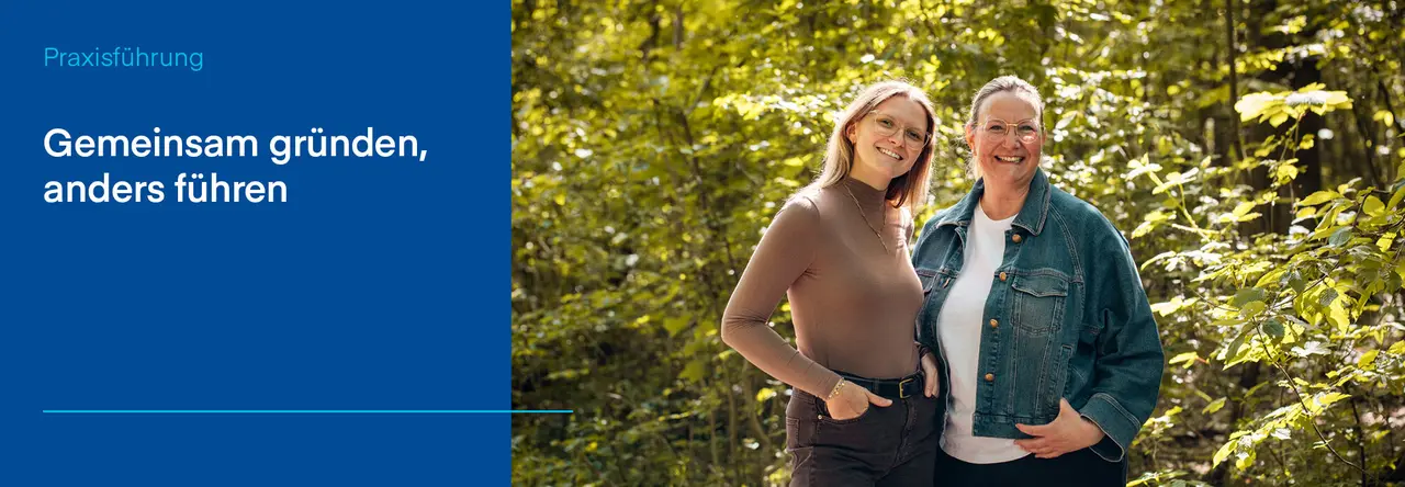 Dr. Elisa Riekert und Dr. Ursula Schönleber stehen lächelnd nebeneinander in einem sonnigen Wald. Links im Bild steht auf blauem Hintergrund der Text: „Gemeinsam gründen, anders führen“.